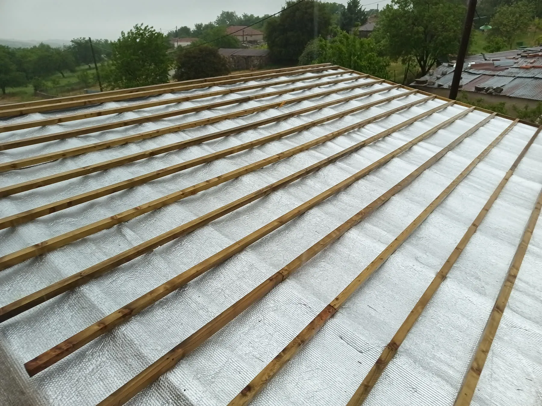 Reflective membrane across a roof plane with timber battens above it