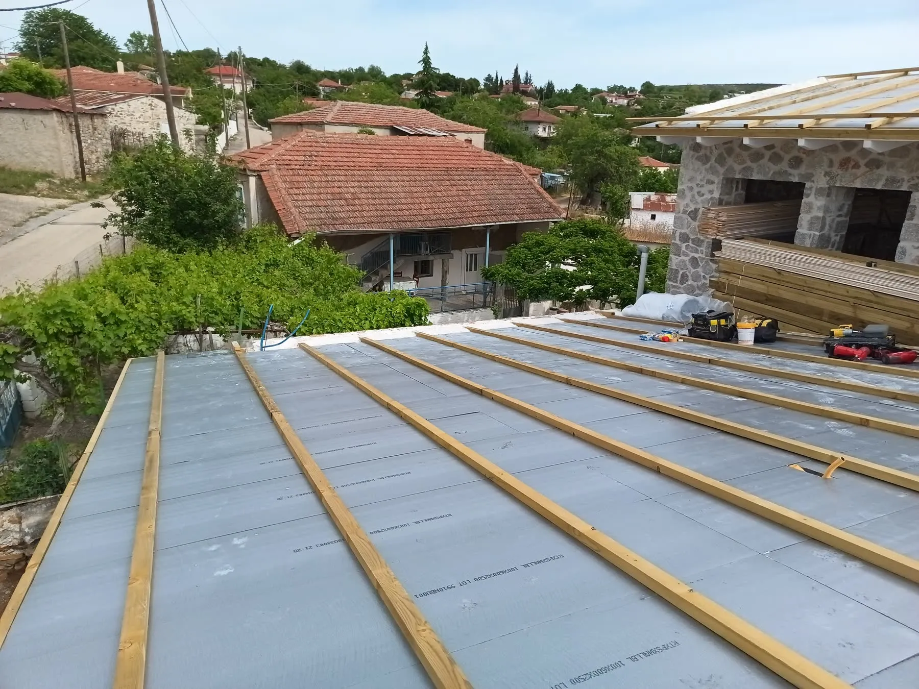 Insulation boards across a roof plane, with timber counter-battens above them